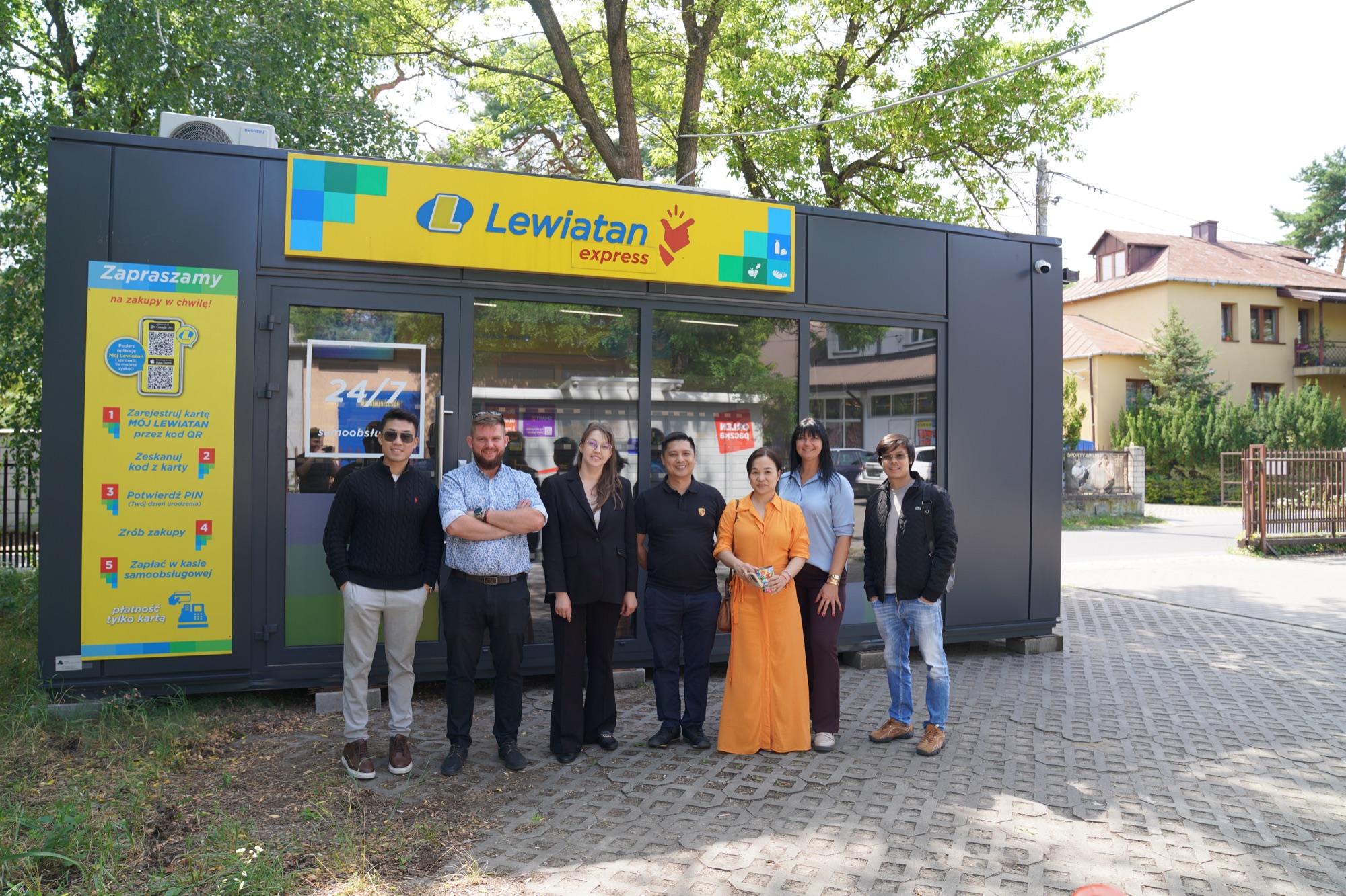 The SmartNovo team and partners in front of a live Lewiatan Express unit